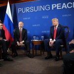 Moment Trump and Putin’s photocall erupts into CHAOS as smirking Vlad tries to shout over journalists before peace talks