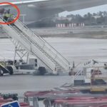 Spanish airport worker filmed hurling bags from plane like an Olympic athlete sparking outrage… but is all as it seems?
