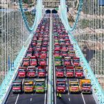 World’s tallest bridge put to the ULTIMATE test as fleet of 96 trucks loaded with 3,360 tons of cargo park on crossing