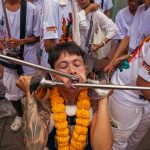 Agonising pics show bizarre ritual where devotees IMPALE themselves with spikes at extreme piercing festival