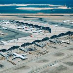 Two dead after plane slides off runway and crashes into car before plunging into sea at Hong Kong airport