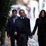 Ex-French pres Sarkozy heads to prison flanked by wife Carla Bruni as he begins 5yr sentence over Gaddafi conspiracy