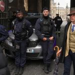Mystery dapper ‘fedora man’ pictured at Louvre heist scene is finally unmasked – and reveals incredible coincidence