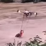 Watch incredible moment drone saves man from drowning in river as relentless flooding submerges houses and kills 55