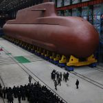 North Korea unveils HUGE nuclear-powered submarine as Kim Jong Un oversees long-range missile launch