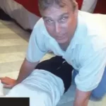 Shamed Andrew seen crouching over woman on the floor in disturbing new photos from latest Epstein file drop