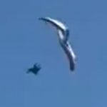 Heart-stopping moment paraglider plunges into sea after losing control 500ft in the air in front of horrified beachgoers