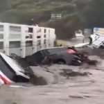 Dramatic moment dozens of cars are swept out to SEA as horror flash floods hit Australia leaving thousands without power
