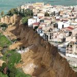 Terrifying vid shows houses teetering on edge of cliff after 4km-long landslide as more than 1,000 evacuate in Sicily