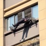 Shock moment elderly man plunges from 15th floor and is miraculously saved by clothing rail hanging from flat window