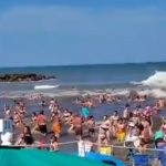 Horror moment deadly ‘meteotsunami’ smashes busy beach as freak ‘30ft wave surge’ kills at least one and injures dozens