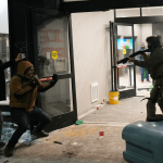 Protesters swarm Minnesota hotel after Alex Pretti shooting leaving officer bloodied as windows smashed & tear gas fired